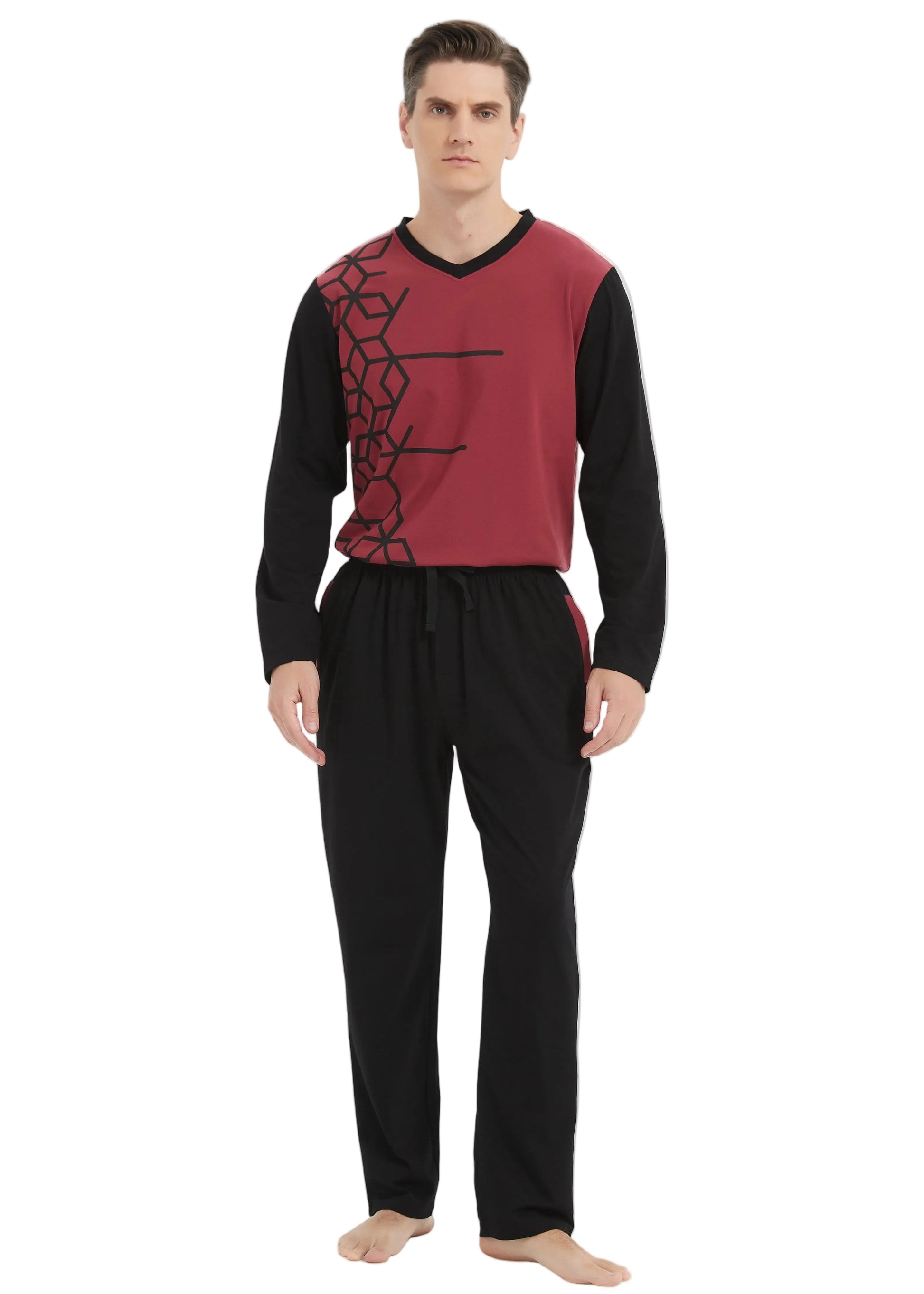A man modeling a two-piece pajama set consisting of a long-sleeve knit top in burgundy and black with a black geometric pattern, paired with black pajama pants, against a plain white studio background.