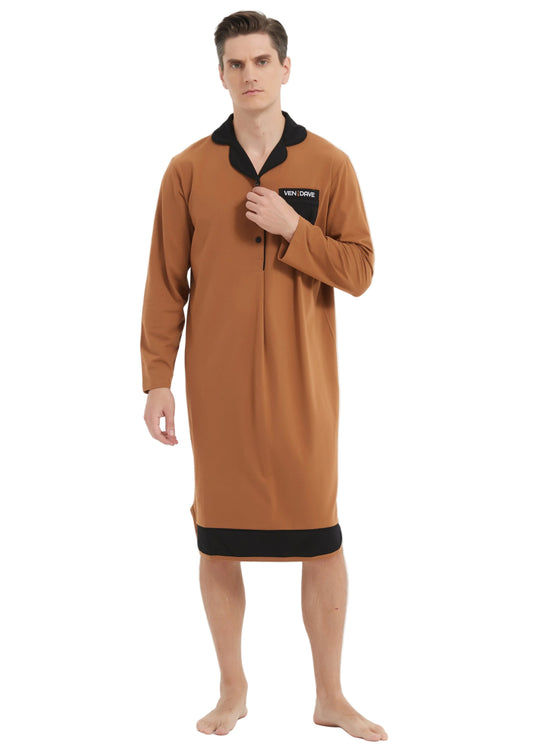 A man modeling a long-sleeve brown nightshirt with black trim on the collar, placket, and hem, standing against a plain white studio background.