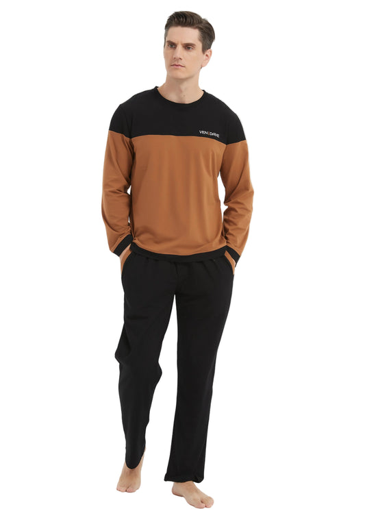 A man modeling a two-tone long-sleeve crewneck sweatshirt with a black upper chest and shoulders and a warm brown lower body, paired with black sweatpants, against a plain white studio background.