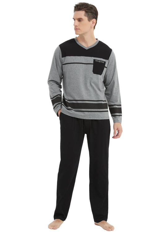 A man modeling a gray and black long-sleeve knit sweater with a chest pocket, paired with black pants, against a plain white studio background.