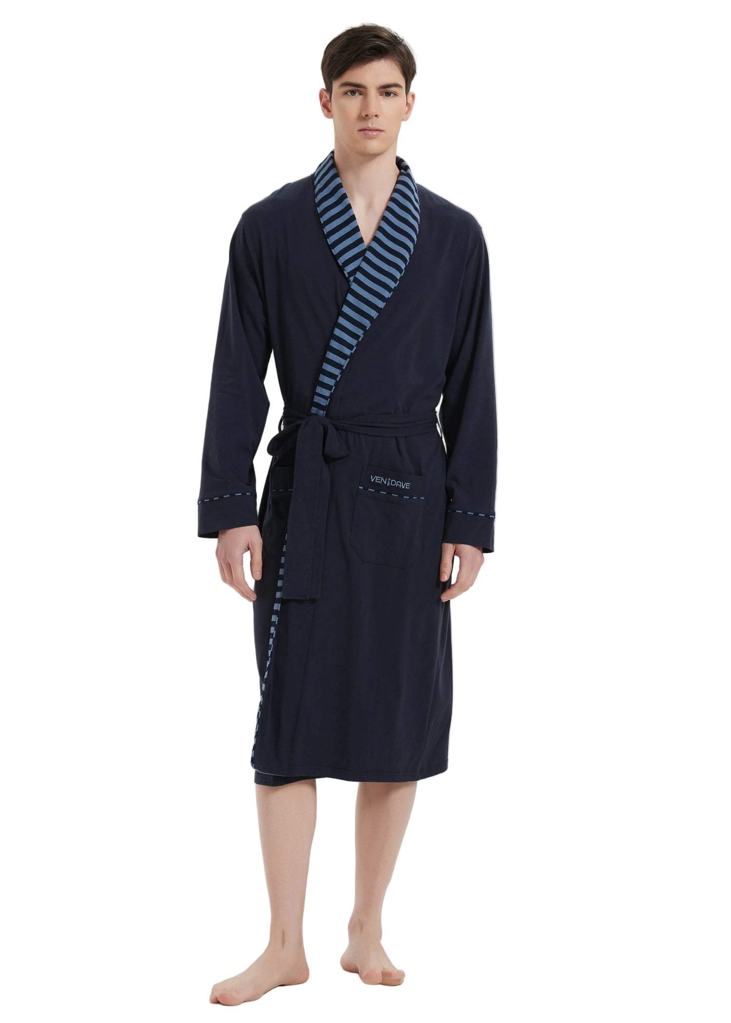 A man modeling a dark navy blue bathrobe with a striped blue and white shawl collar and matching tie belt, standing against a plain white background.