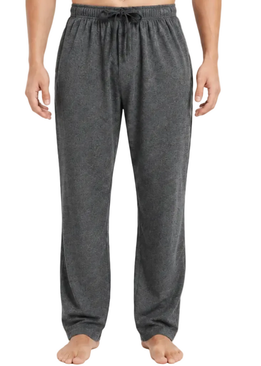 A person modeling dark gray heather lounge pants against a plain light gray studio background.