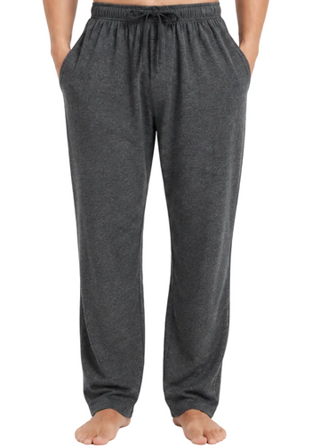 A person wearing dark gray heather lounge pants with an elastic drawstring waistband and side pockets, standing barefoot against a light gray studio background.