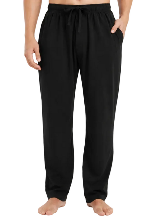 A person modeling black drawstring lounge pants against a clean white studio background.
